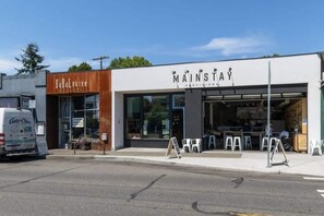 A storefront with a sign reading "MAINSTAY PROVISIONS" and another sign for "Baba Lounge". - Ballard Hot Tub Retreat + Fenced Yard + Walk to Cafes Dining & Breweries (Seattle)