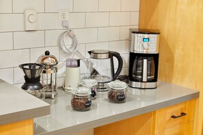 Enjoy brewing your favorite coffee with the kitchen's coffee maker, grinder, and kettle.