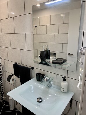 Shower, hair dryer, towels, soap