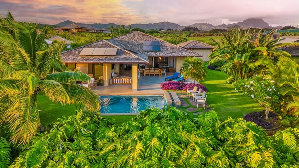 A house with a swimming pool surrounded by lush greenery and palm trees. - Maluhia Makai: Tropical Villa (Koloa)