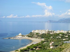 A coastal town with a prominent white church, a beach, and a marina. - Arborea by Interhome (Sperlonga)