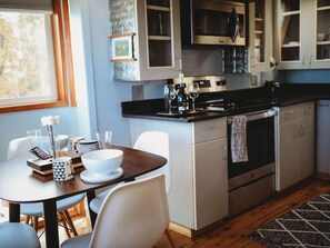 Fridge, microwave, coffee/tea maker, cookware/dishes/utensils