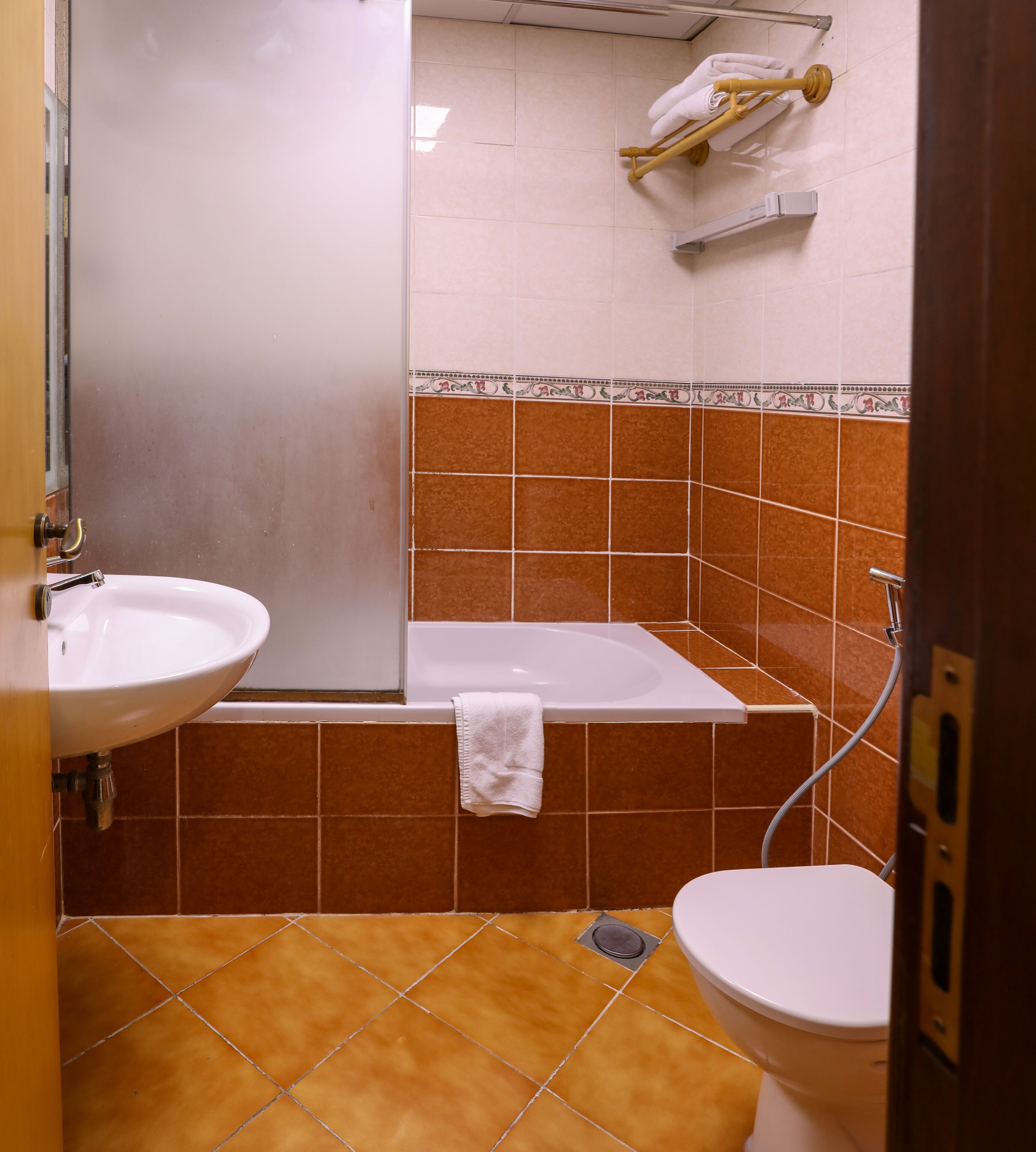 A bathroom with a sink, toilet, and bathtub.