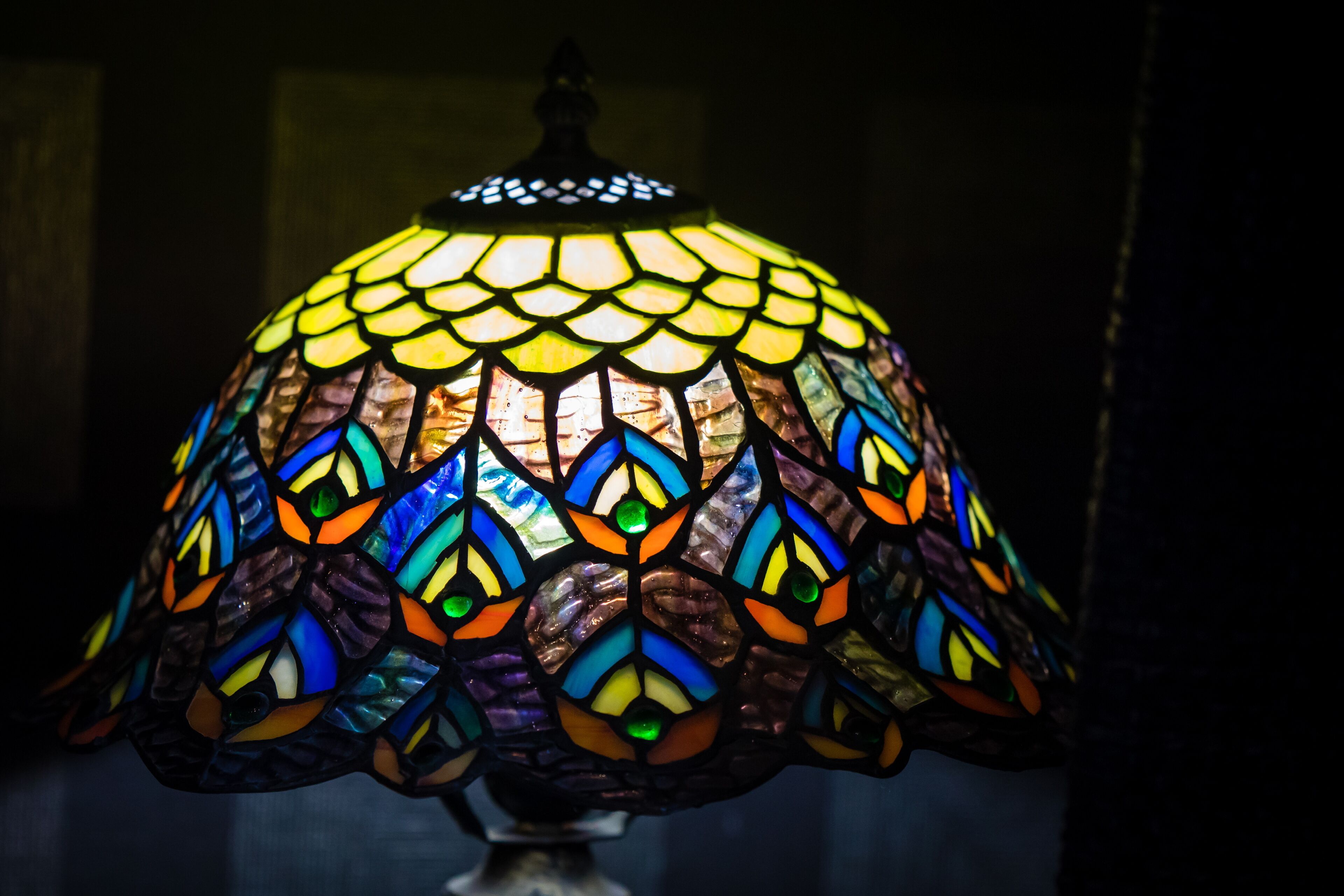 A close-up of a stained glass lamp with a geometric pattern.