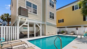 A pool area with lounge chairs and a covered seating area. - 6-Bedroom Surfside House with Private Pool and Beach Access (Surfside Beach)