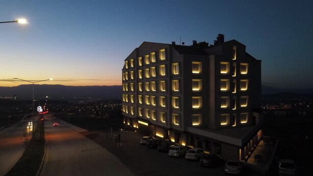 A multi-story hotel with a modern design, featuring a row of uniformly lit windows and a flat roof. - The Erzurum Hotel (Erzurum)