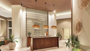 A modern reception area with a wooden reception desk, pendant lighting, and decorative wall art. - Beachfront Luxury Condo, Great Location! (Puerto Vallarta)