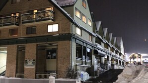 A multi-story hotel with a brick facade, balconies, and a sign indicating it is a hotel.