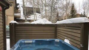 A hot tub in a wooden enclosure with a snowy background. - Charming 2 BDR Getaway w/ Views & Private Hot Tub! (Park City)