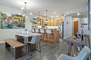 A modern kitchen with wooden cabinets, a central island, and pendant lighting. - 3BDR Condo Heart of Old Town Walk to Town Lift (Park City)