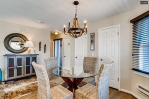 A refined dining area near the living area is an ideal place to enjoy a delicious meal or set up your favorite board game with seating for four.