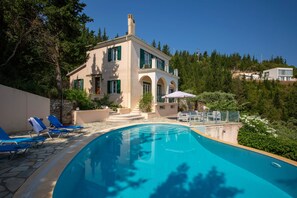 An infinity pool, sun loungers