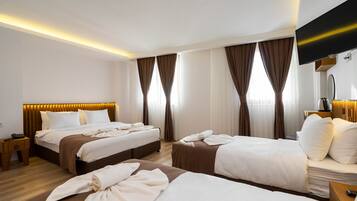 Family Quadruple Room | Minibar, in-room safe, desk, laptop workspace