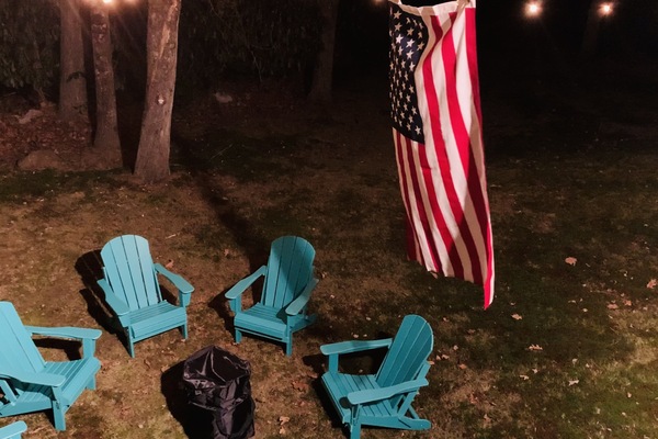 Solo Stovefirepit on the back yard is under string lighting.