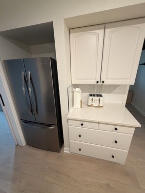 A compact kitchen with a stainless steel refrigerator, a white countertop, and a toaster. - Walk to Beach 2- Patios Updated Lux Retreat NEW Heated Pool Sleeps 10 Small Dogs (Naples)