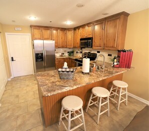 Enjoy cooking in this well-equipped kitchen with a gas stove, microwave, and refrigerator.