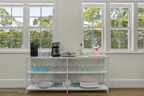 A kitchen area with a coffee maker, a scale, and various kitchen items on a shelf. - Luxury 8BR Home w/ Pickleball, Pool & Spa (Santa Rosa Beach)