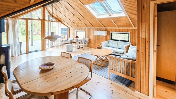 A wooden interior with a dining area, seating, and a TV. - 3 bedroom gorgeous home in Væggerløse (Væggerløse)