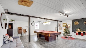 A spacious room with a pool table, a sofa, a Christmas tree, and dartboards. - Pet friendly apartment in Esbjerg V (Esbjerg V)
