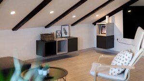 A modern loft bedroom with a sloped ceiling, built-in shelving, and a large window. - Stunning home in Slunj with swimming pool (Slunj)