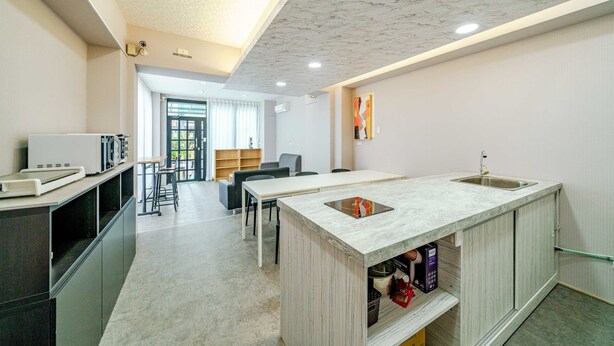 A modern kitchen with a marble countertop, built-in appliances, and a central island. - Dingai Holiday Museum (Jiaoxi)