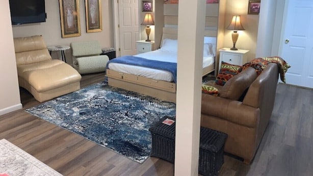 A hotel room with a bed, a sofa, a TV, and a desk. - Lovely Lovelock Landing (Lovelock)