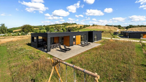 A modern, two-story building with a patio area featuring outdoor seating and a hot tub. - Pet friendly home in Løgstrup with WiFi (Løgstrup)