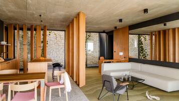 A modern interior with a dining area, a sofa, and a coffee table.