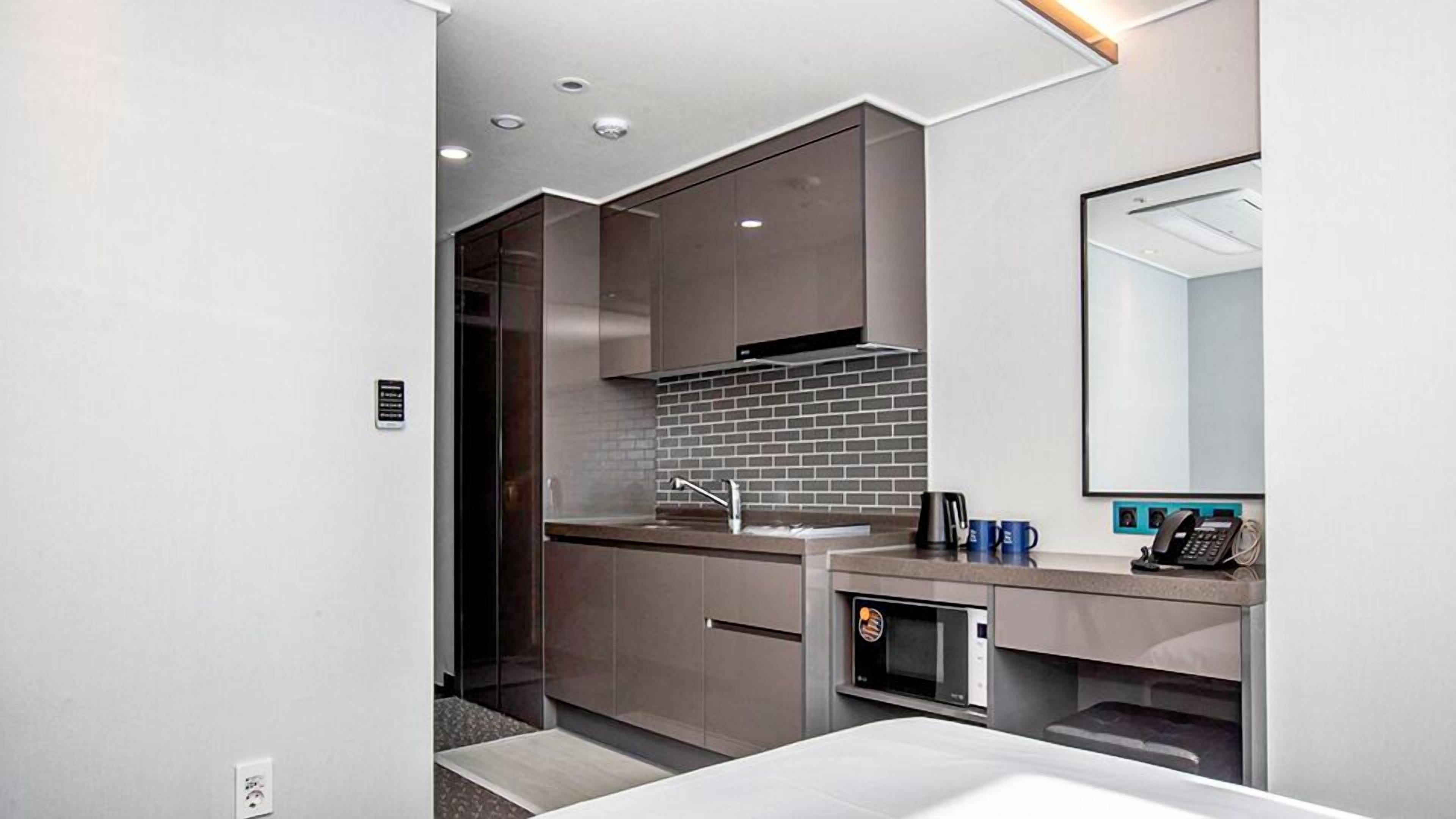 A modern bathroom with a shower, sink, and mirror.