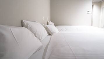 Economy Triple Room, Non Smoking (No daily cleaning) | Down comforters, desk, blackout drapes, soundproofing