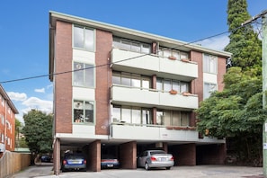 A multi-story residential building with a parking garage.