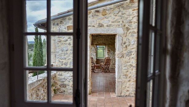An open door leading to a stone-walled room with a tiled floor and a window. - Magnificent private Mas Ardechois with swimming pool (Labastide-de-Virac)