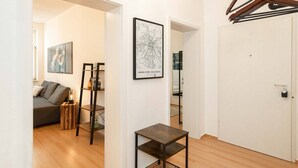 A modern living room with a sofa, a small table, and a map on the wall.