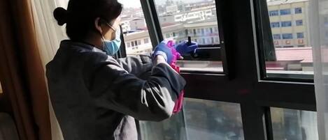 A person cleaning a window with a squeegee.