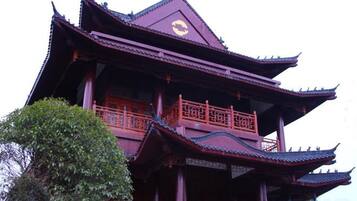 A multi-tiered pagoda-style building with ornate railings and a traditional roof.