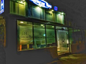 Welcome to the American Visa Hotel, where a prominent logo marks the entrance.