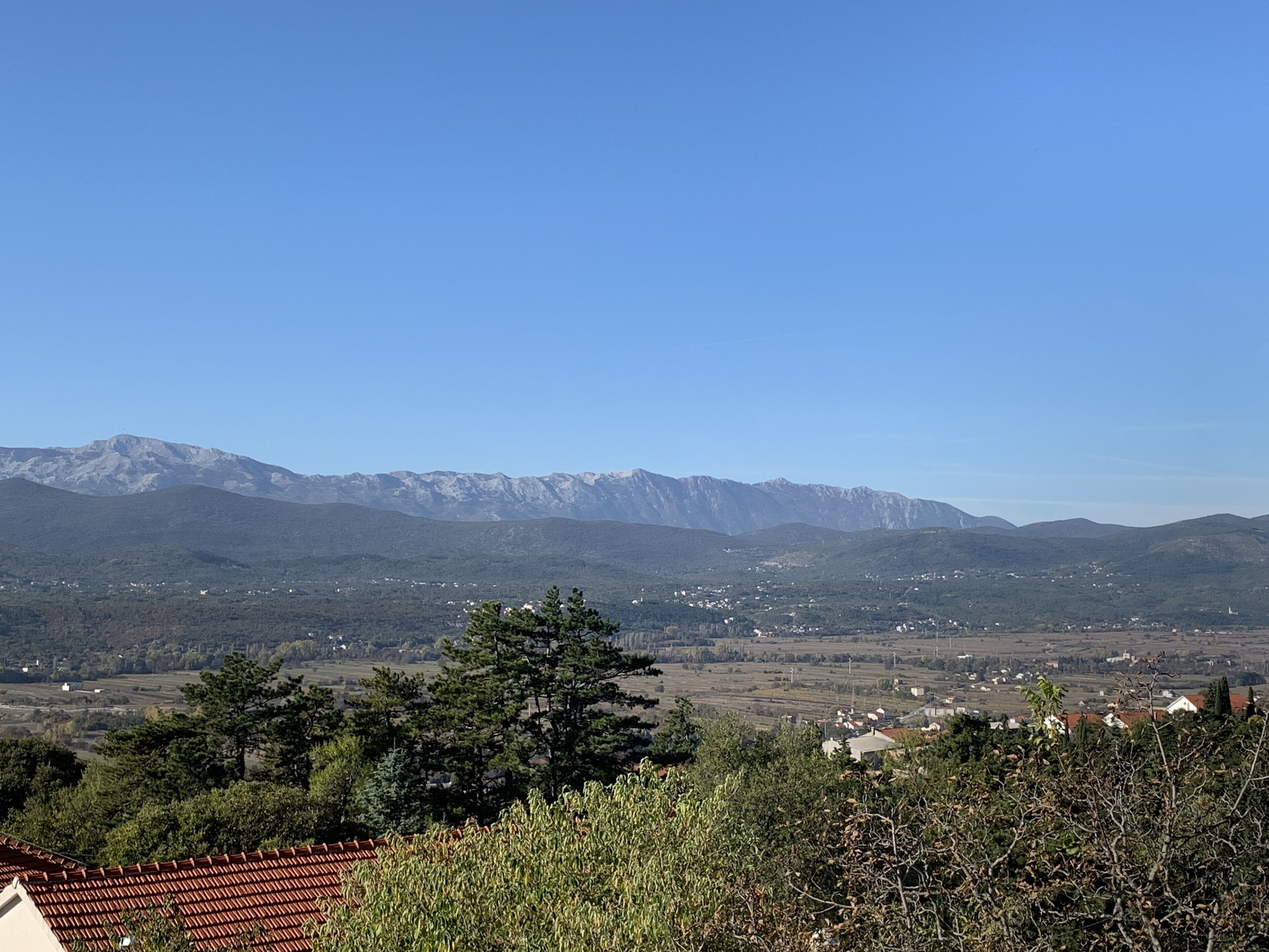 A mountainous landscape with a village in the valley.