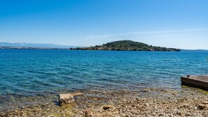 A rocky shoreline with clear water and a distant island. - Apartment by the sea and With Beautiful View, 2 Bedrooms, 4 Persons (Kali)