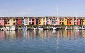 Waterfront buildings with flat roofs and balconies offer a serene view of the surrounding waters.