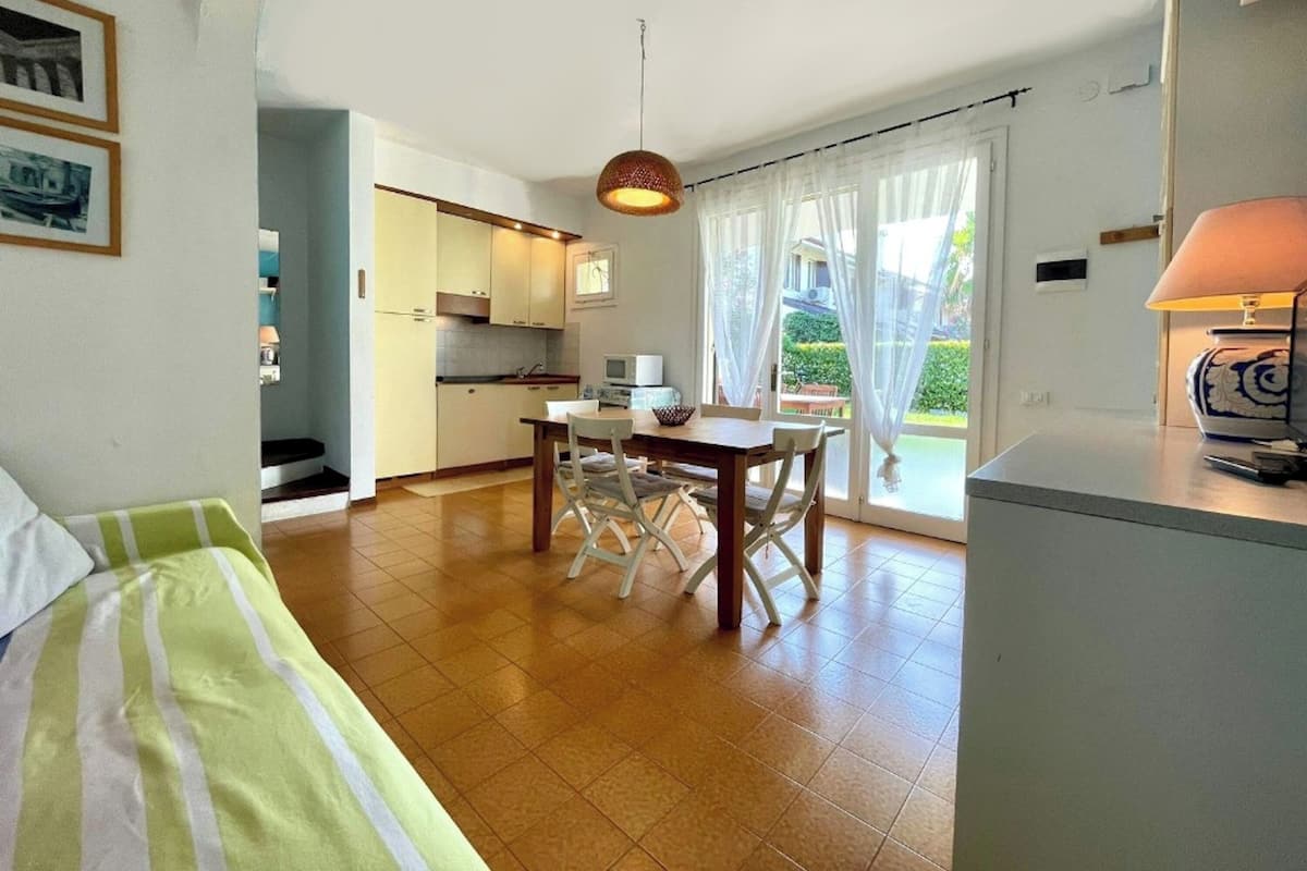A compact living space with a kitchen, dining area, and a bedroom.
