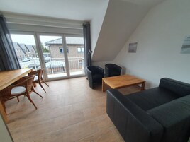 Comfort Condo | Living area | 32-inch flat-screen TV with satellite channels, TV