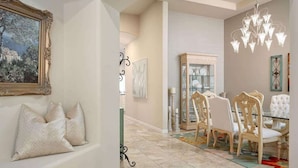 A dining area with a glass-top table, ornate chairs, and a chandelier. - Camelback Corridor, 5 min from Airport, Pool & Sun (Phoenix)