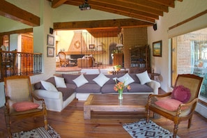 A cozy living room with a sectional sofa, wooden coffee table, and two armchairs. - Country House In The Woods With River (Valle de Bravo)