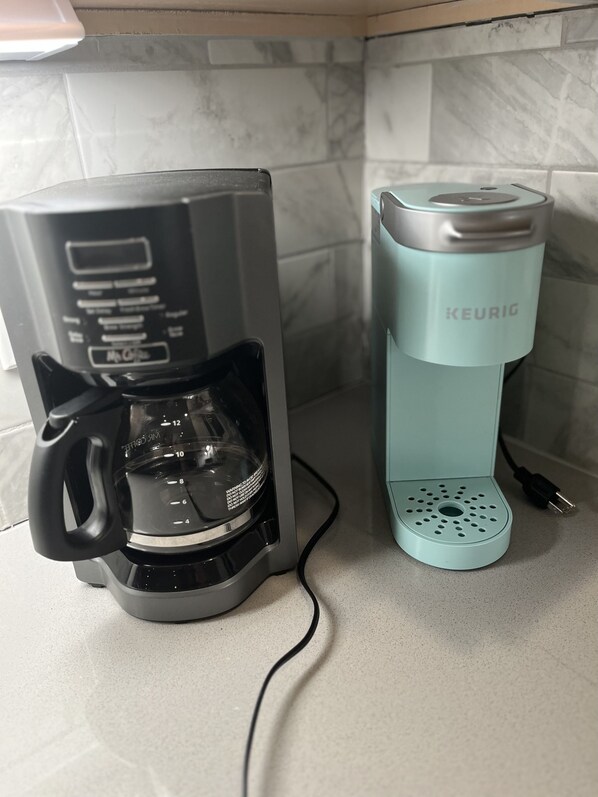 A coffee maker and a Keurig pod machine on a kitchen counter.