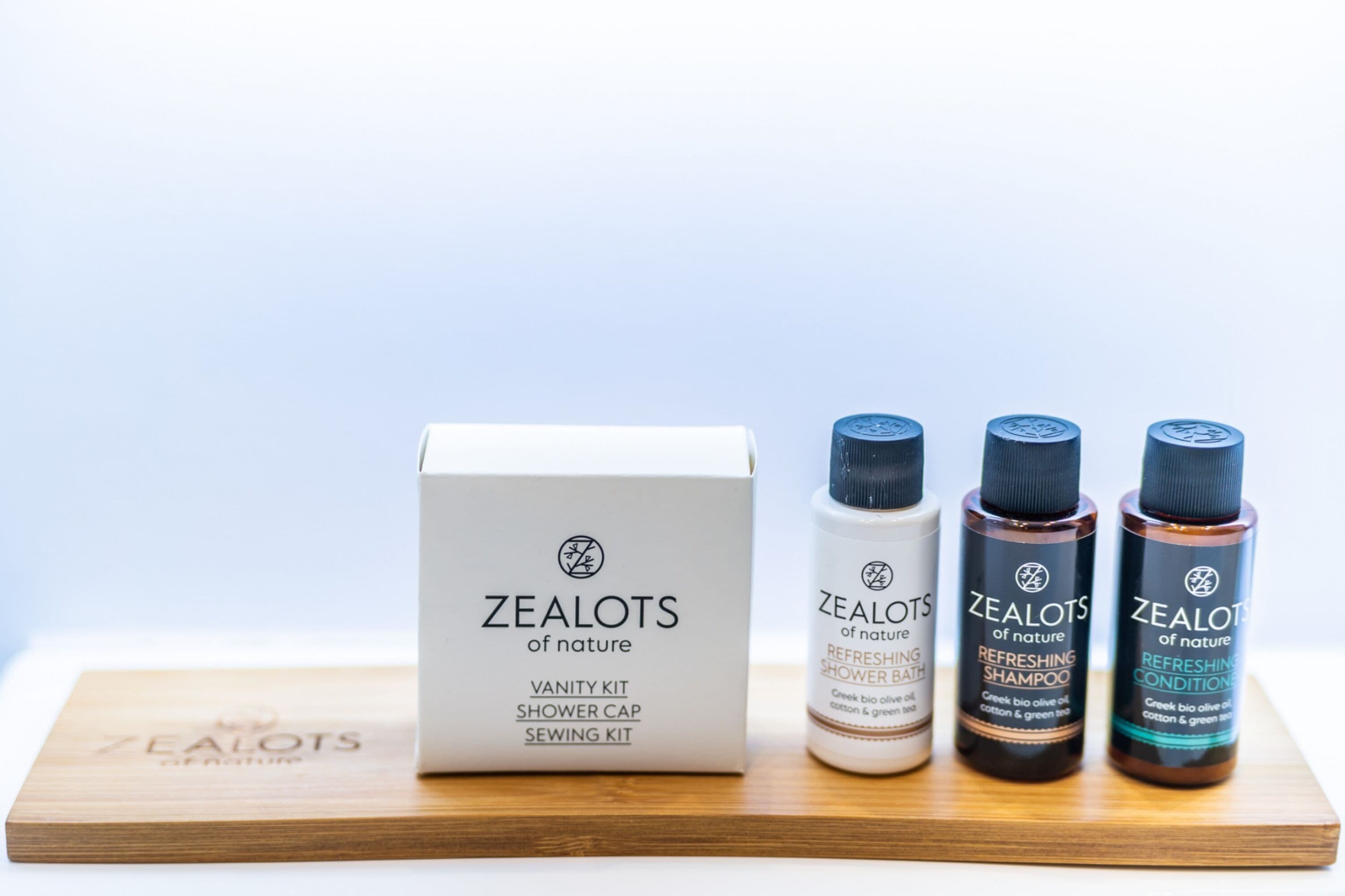 A vanity kit, shower cap, and sewing kit from Zealots of Nature, along with three bottles of refreshing shower products.