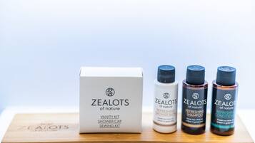A vanity kit, shower cap, and sewing kit from Zealots of Nature, along with three bottles of refreshing shower products.