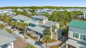A residential area with multiple two-story houses, each featuring a balcony and a front porch. - Gorgeous, spacious home, steps to the 12,000sqft pool, recently renovated. Perfect for the whole family! (Panama City Beach)