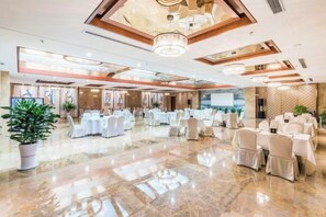 A spacious banquet hall with multiple round tables, chairs, and a polished marble floor. - Yongchang Hotel (Baoshan)
