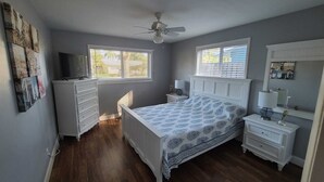 A bedroom with a bed, dresser, nightstands, and a ceiling fan. - Hollywood getaway near all points of interest (Hollywood)