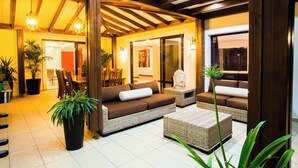 A modern interior with a sofa set, a coffee table, and potted plants.